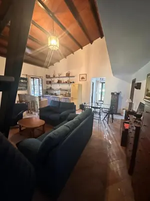 a living room with blue couches and a table at Casa Rural Los Murtales in Alcalá de los Gazules