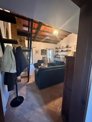 a living room with a couch and a loft at Casa Rural Los Murtales in Alcalá de los Gazules