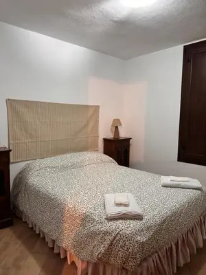 a bedroom with a bed with two towels on it at Casa Rural Los Murtales in Alcalá de los Gazules