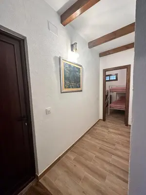 a hallway of a house with a painting on the wall at Casa Rural Los Murtales in Alcalá de los Gazules