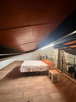 a bedroom with a bed and a table on a balcony at Casa Rural Los Murtales in Alcalá de los Gazules