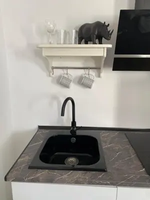 a kitchen counter with a sink and a shelf at ESTUDIO CON TERRAZA CHILL in El Puerto de Santa María