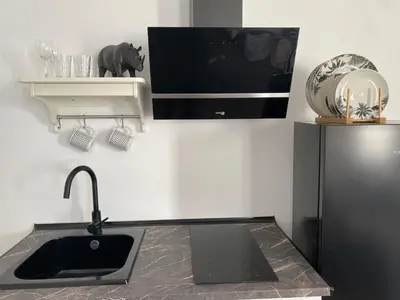 a kitchen with a sink and a refrigerator at ESTUDIO CON TERRAZA CHILL in El Puerto de Santa María