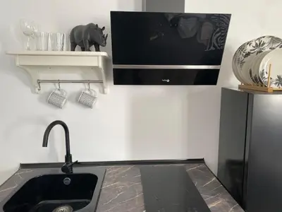 a kitchen with a sink and a refrigerator at ESTUDIO CON TERRAZA CHILL in El Puerto de Santa María