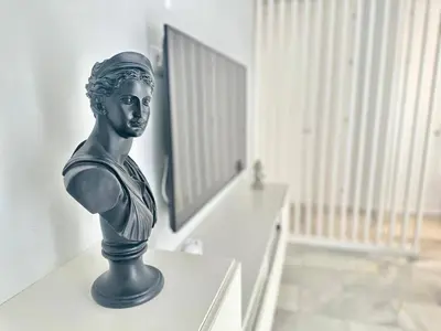 a statue of a bust sitting on a desk at Apartment in Plaza Arenal in Jerez de la Frontera