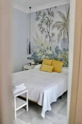 a bedroom with a large bed with yellow pillows at Apartment in Plaza Arenal in Jerez de la Frontera