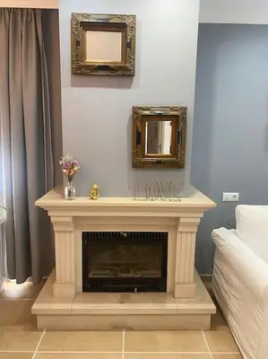 a living room with a fireplace and a mirror at Villa La Calma in El Puerto de Santa María