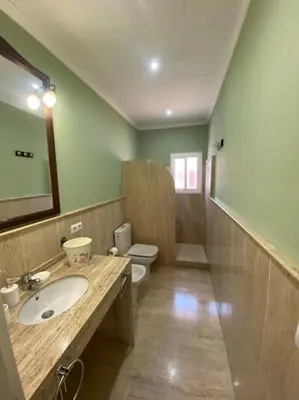 a bathroom with a sink and a toilet at Villa La Calma in El Puerto de Santa María