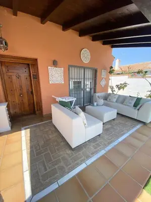 a living room with white couches in a room at Villa La Calma in El Puerto de Santa María