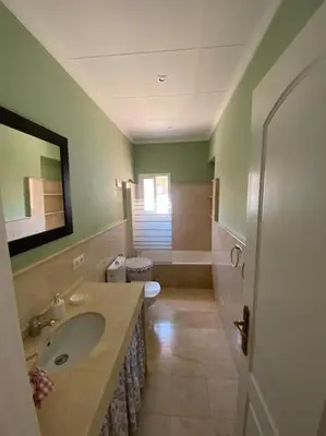 a bathroom with a sink and a toilet at Villa La Calma in El Puerto de Santa María