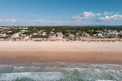 an aerial view of a beach with houses and buildings at Apartamento a pie de playa. in Chiclana de la Frontera