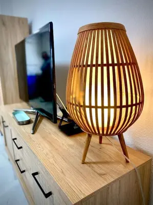 a lamp sitting on top of a dresser with a television at MyChoice Pitiusa in Rota