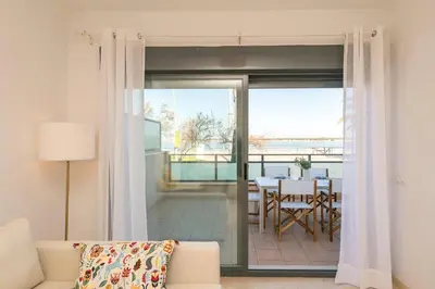 a living room with a couch and a sliding glass door at Atardecer en Sanlúcar in Sanlúcar de Barrameda