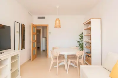 a white dining room with a white table and chairs at Atardecer en Sanlúcar in Sanlúcar de Barrameda