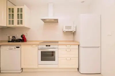 a kitchen with white appliances and a white refrigerator at Atardecer en Sanlúcar in Sanlúcar de Barrameda
