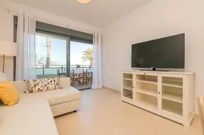 a living room with a television and a couch at Atardecer en Sanlúcar in Sanlúcar de Barrameda