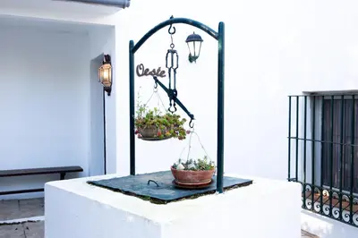 a plant stand with two potted plants on it at Casa rural con piscina en Conil de la Frontera - Casa Oeste in Cádiz
