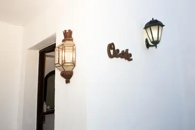 two lights on the side of a wall with a mirror at Casa rural con piscina en Conil de la Frontera - Casa Oeste in Cádiz