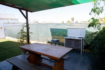 a picnic table with a laptop on top of it at Casa rural con piscina en Conil de la Frontera - Casa Oeste in Cádiz