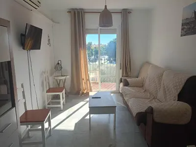 a living room with a couch and a table at Apartamento El Niño de Oro in Sanlúcar de Barrameda