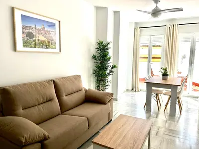 a living room with a couch and a table at Alojanómadas Jerez Centro in Jerez de la Frontera