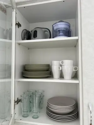 a cabinet filled with plates and cups and dishes at Alojanómadas Jerez Centro in Jerez de la Frontera