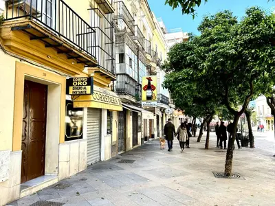 a group of people walking down a city street at Alojanómadas Jerez Centro in Jerez de la Frontera