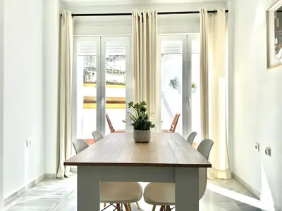 a dining room table with a potted plant on it at Alojanómadas Jerez Centro in Jerez de la Frontera