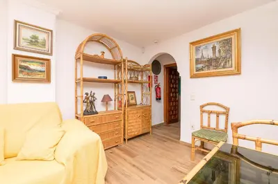 a living room with a couch and a chair at El Paseo del Faro in Chipiona