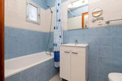a bathroom with a toilet and a tub and a sink at El Paseo del Faro in Chipiona