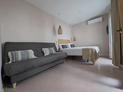 a living room with a couch and a bed at Mina32 by 7Escalones in Rota