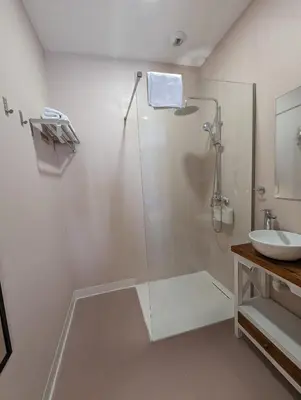 a bathroom with a glass shower and a sink at Mina32 by 7Escalones in Rota