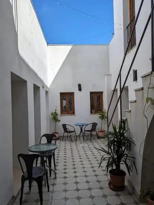 a patio with tables and chairs in a building at Mina32 by 7Escalones in Rota