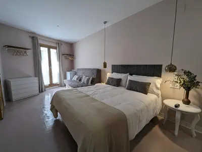 a bedroom with a large bed and a couch at Mina32 by 7Escalones in Rota