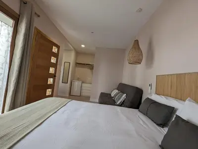 a bedroom with a large bed and a couch at Mina32 by 7Escalones in Rota