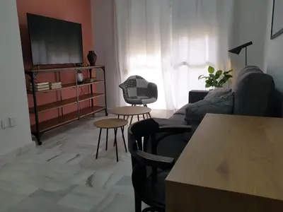 a living room with a couch and a table at Las Antillas by RentCadiz in El Puerto de Santa María