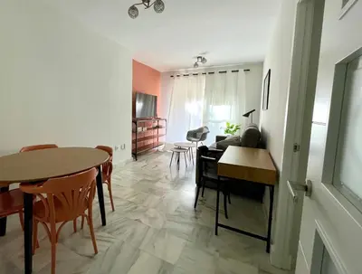 a room with a table and chairs and a living room at Las Antillas by RentCadiz in El Puerto de Santa María