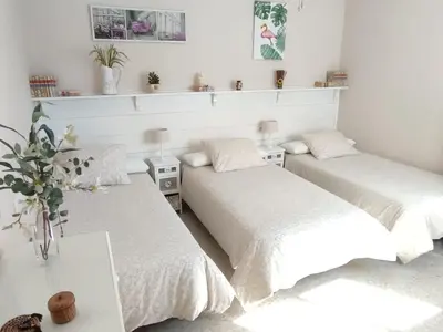 two beds with white sheets in a bedroom at Mina42 by 7Escalones in Rota