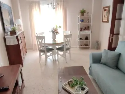 a living room with a table and a blue couch at Mina42 by 7Escalones in Rota