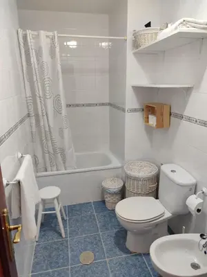 a bathroom with a toilet and a tub and a sink at Mina42 by 7Escalones in Rota