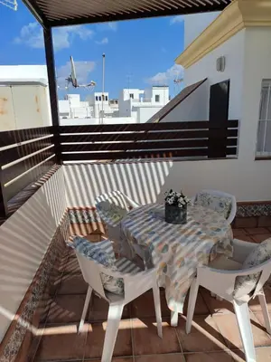a table and chairs sitting on a balcony at Mina42 by 7Escalones in Rota