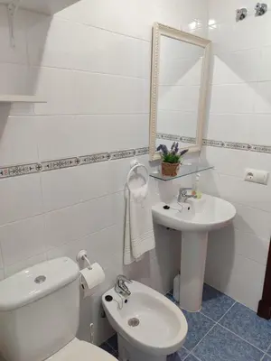 a white bathroom with a toilet and a sink at Mina42 by 7Escalones in Rota