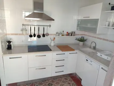 a kitchen with white cabinets and a sink at Mina42 by 7Escalones in Rota