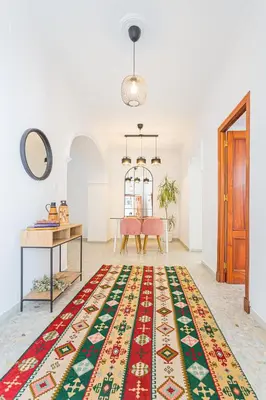 a room with a table and a rug on the floor at Carril San Diego, junto a la Plaza Cabildo in Sanlúcar de Barrameda