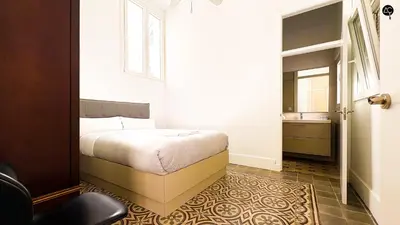 a bedroom with a bed and a window and a mirror at Casa Plaza Candelaria Cádiz Grupo AC Gestión in Cádiz