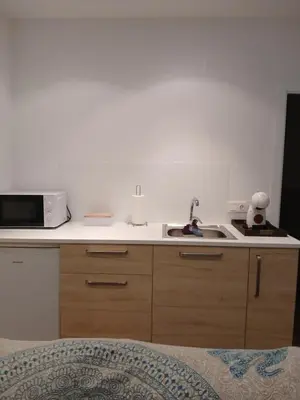 a kitchen with a sink and a microwave at Residencial Golf jerez in Jerez de la Frontera