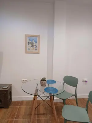 a dining room with a glass table and chairs at Residencial Golf jerez in Jerez de la Frontera
