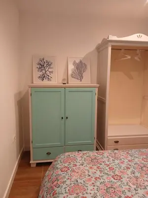 a bedroom with a bed and a green cabinet at Residencial Golf jerez in Jerez de la Frontera