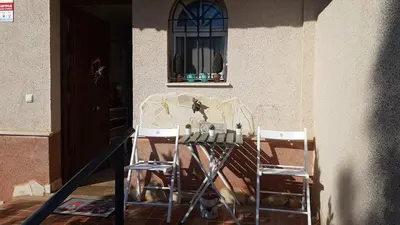 a table and two chairs in front of a building at Residencial Golf jerez in Jerez de la Frontera