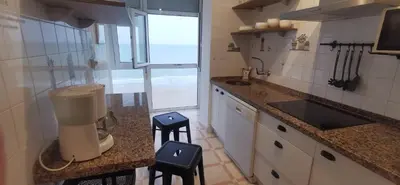 a kitchen with a blender on a counter with two stools at ARENA y Mar Sunny Home by Cadiz4Rentals in Cádiz